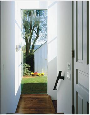 Heart-pine floors serve the same purpose in the stairs and hallway leading to the addition.