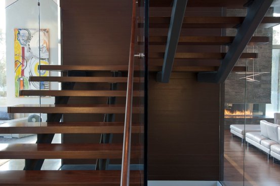Dark wood floating stairs at Beverly Hills modern home.