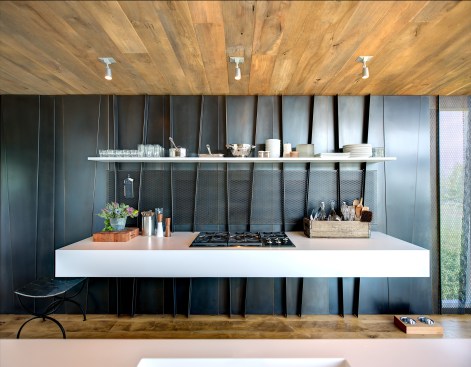 The folded wall steel panels serve as a structural unit in the kitchen.