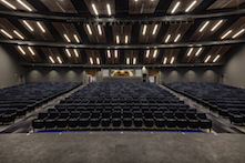 Forming the 17 clouds above the performing arts' audience seating area, Rockfon® Planostile™ lay-in aluminum ceiling panels were acoustically improved with an Acoutex™ backer.