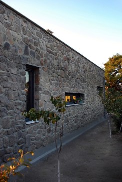 east facade with thin horizontal and vertical ribbon windows.