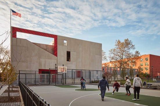 The east façade, seen here from the adjacent neighborhood basketball court, is primarily composed of insulated precast panels from the High Concrete Group.