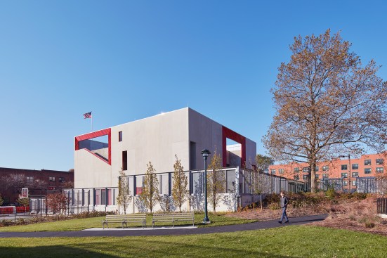 The voids incorporated into the top of the structure frame an exterior staircase and terraces, and serve as a functional metaphor: They offer spaces for training, while also referencing the fact that firefighters often cut openings into burning buildings so they can rescue occupants and allow smoke to vent. 