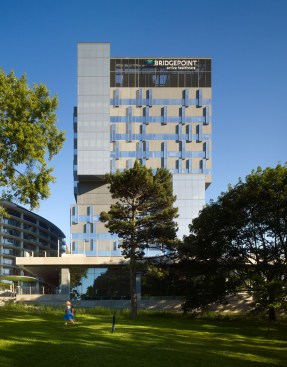 View of the 10-story building from the neighboring Riverdale Park.