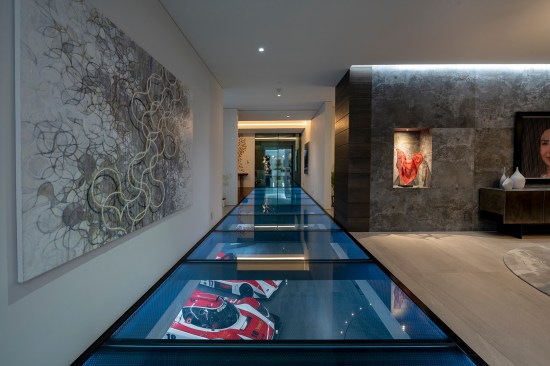 Serenity Indian Wells modern mansion glass bridge walkway with views of the luxury car garage
