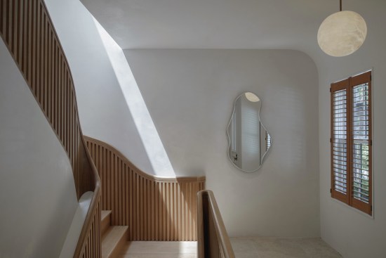In Boston’s Hairpin House, also designed with Studio J.Jih, a “hairpin stair” meanders through a 40-foot-high atrium, according to the firm.