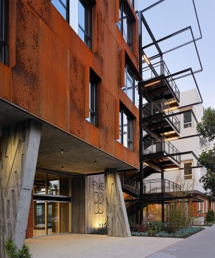 Concrete piers contrast with perforated Cor-Ten on the south façade.