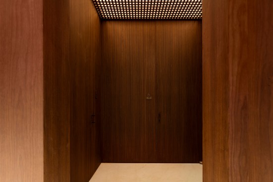 Restroom vestibule showing uplit ceiling above wooden lattice, Four Seasons Restaurant, New York