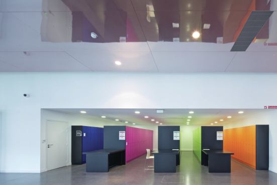 The minimal palette continues inside, with bursts of color in archives’ storage. 