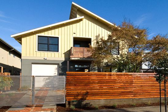 The rear of one of the homes faces the street (shown), the other backs up to an alley. Near public transit and shopping, the houses achieved a Walk Score of 86 of 100. To fit into the neighborhood, both units are sized to a similar scale of other houses on the block.
