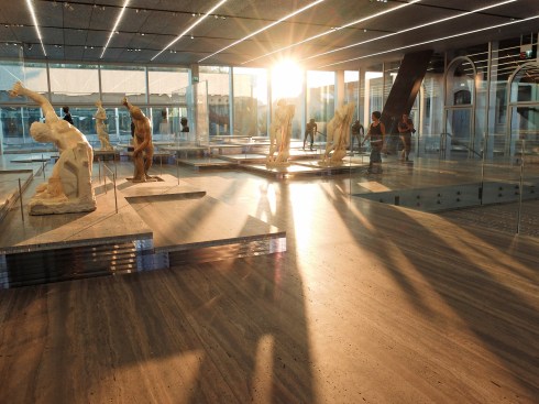 The ground-level gallery in the Fondazione's Plinth building, showing travertine platforms supported by clear acrylic.