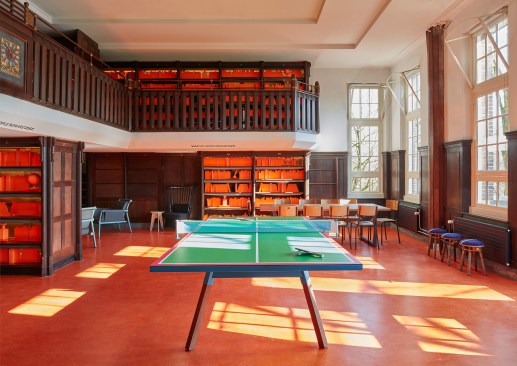 The library now serves as an event space and lounge area, and features orange marmoleum flooring.