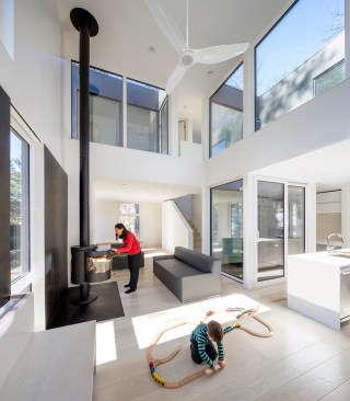Double-height living area with view into kitchen (at right)