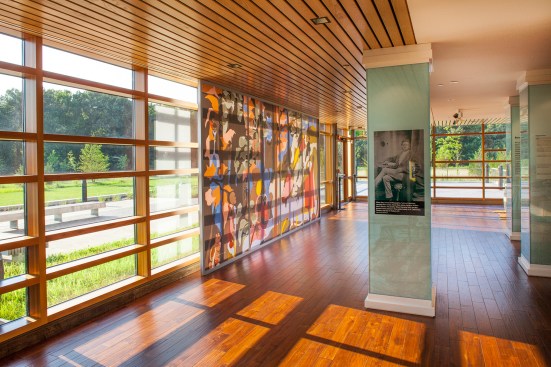 The windows in the visitor center offer views of the surrounding landscape and woods to the north