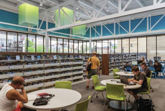 Light monitors break through the ceiling plane in the south reading room. The blue-hued “frieze” helps dampen sound.