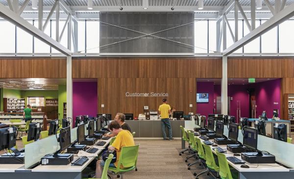 Allsteel benching with computer terminals exemplify the library’s evolving role in the information age. The lime green children’s area, at left, features letterforms suspended flat from the ceiling.