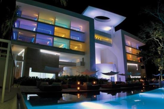 The hotel’s façade at night is a collage of color.