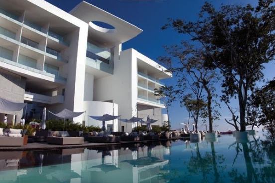 A view of the hotel and the pool area during the day.