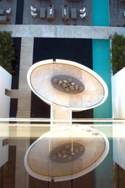 Looking down at one of the outdoor lounge areas, a stand-alone tower reached by walkway.