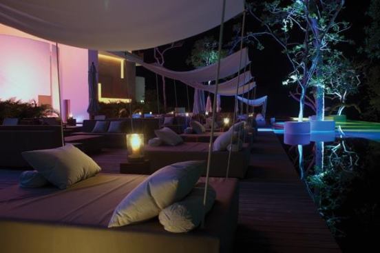 Carefully places light creates a serene and seductive atmosphere at the poolside bar and lounge area.