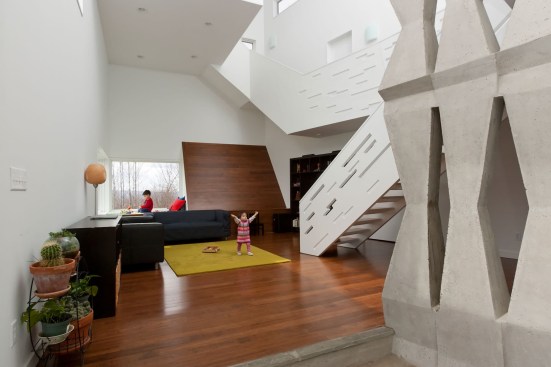 The 2,200-square-foot Hsu House residence in Danby, N.Y., features solar-responsive siding and a cast-in-place concrete mass wall that speeds thermal transfer of heat from the sun, filters light into the first floor, and functions as a sculptural focal point.