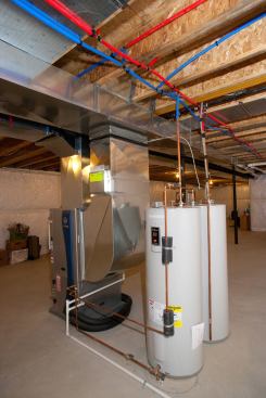 The WaterFurnace Envision geothermal heat pump system not only heats and cools the home, but pre-heats the home’s hot water so the two water heaters don't have to work as hard.