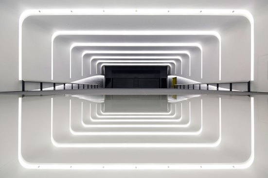 Stage lights in the front most cove, directional downlights, ambient covelighting and linear accents on walls provide layers of light for a dynamic experience.
