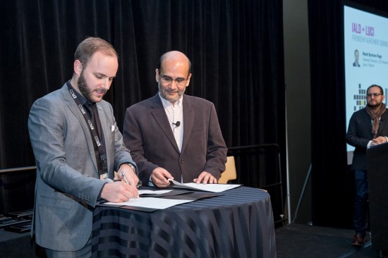 Mark Burton-Page, General Director of LUCI (left) and Victor Palacio, 2016-2017 IALD President (right) sign a Friendship Agreement during the IALD Enlighten Americas conference in Denver. Incoming IALD President David Ghatan (far right) looks on.