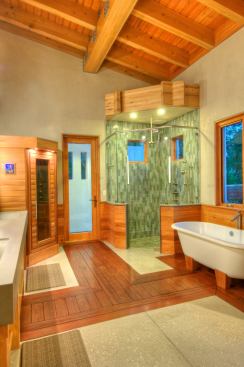 Like the living room, the master bath’s floors stay soft underfoot with wood inlays added to the concrete.