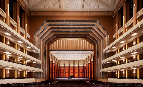 The main performance space, the 2,050-seat Reynolds Hall, is designed to host orchestra, opera, dance, and Broadway productions (this photo). It is almost completely lit with line-voltage incandescent lamps; no ballasts or transformers are allowed because of the hall's acoustical requirements. The exception is the 8.9W surface-mounted LED fixtures placed at regular intervals along the balcony fronts as well as edge-lit LED spires (next photo).