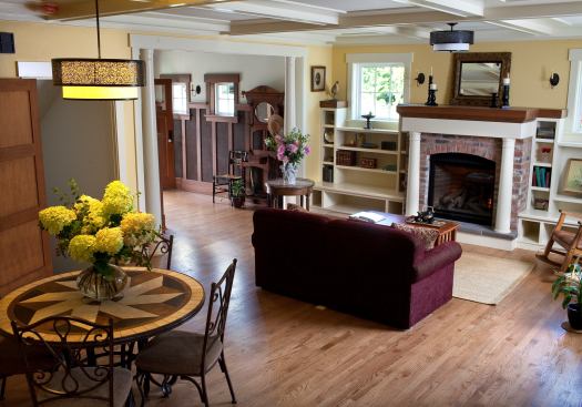 Inside, coffered ceilings, a recycled-brick fireplace, and built-in shelves add to the cottage feel.
