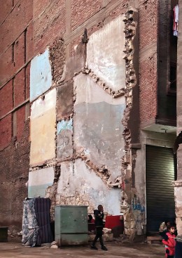A demolished appendage to a larger building tells a sectional story about its prior use.