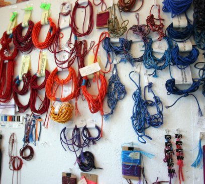 Different types of threads, strings, and fibers on a material wall in Echelman’s studio in Brookline, Mass.