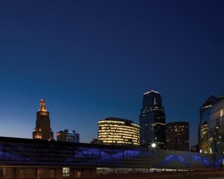 A view of the bridge at night with downtown Kansas City beyond.