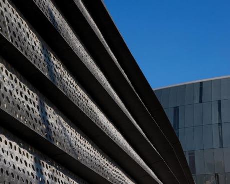 An exterior view of the bridge’s perforated zinc skin.
