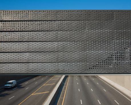 The undulating zinc skin creates a subtle pattern of shadows during the day.
