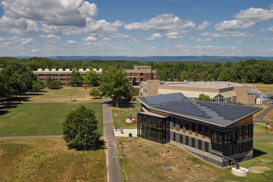 By rerouting an existing dead end road and strategically siting the new building, the project frames a new campus quad.