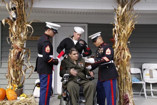 26-year-old Corporal Visnu Gonzalez receives the keys to his new home from fellow Marines on Nov. 10. 