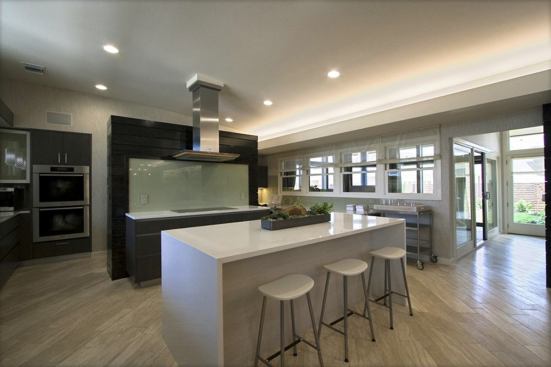 The open kitchen features integrated Miele stainless steel appliances and Caesarstone quartz, limestone, and concrete countertops.