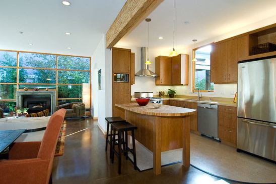 Concrete floors store solar energy and release it into the home during cooler nighttime hours. The Amana refrigerator and Bosch dishwasher are Energy Star-labeled.