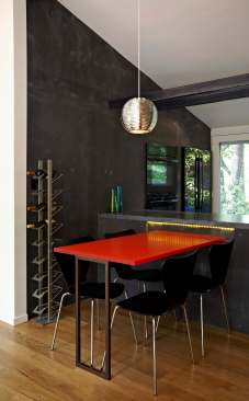 The dining room table on the other side of the kitchen counter is equally colorful.