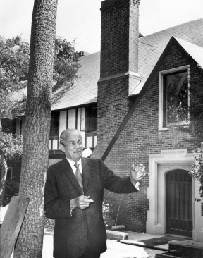 Architect Paul Revere Williams in 1970, standing in front of a restored tudor-style mansion that he designed in Bel-Air in 1928.
