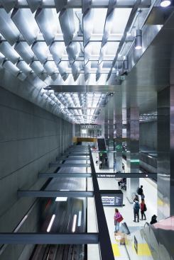 The underground rail station receives ample light from above.
