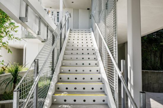 Staircade leading to exterior circulation lining the courtyard.