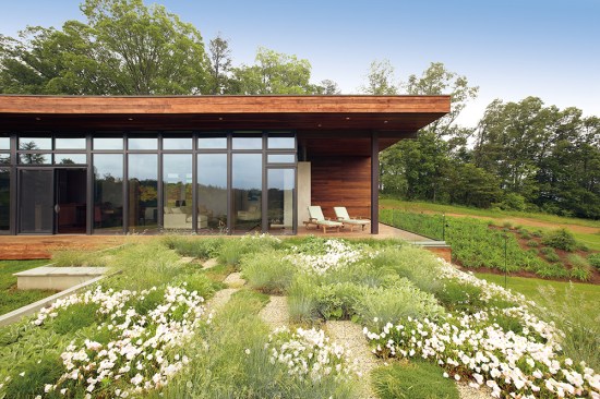 
  The
  Lecicester home is a modern and minimal example of architectural brilliance.
  The home is placed perfectly amongst its wide-open surroundings.&nbsp; A broad range of standard Marvin window and
  door options were all carefully coordinated with the very professional Marvin
  team. The solution of a window wall along the south and west fa&ccedil;ades of the
  upper level brings the outdoors in. This custom configuration of standard
  Marvin products is integral to the vision of the house, as well as the
  economics of its construction. Punched windows in the lower level, also by
  Marvin, contrast nicely with the expression of the main living area. A
  continuous transom of glass at the entry fa&ccedil;ade allows morning light to
  dapple across the interior ceiling. The fenestration was integral to the very
  premise of the house, unifying the interiors with the site’s mountain
  views.&nbsp;