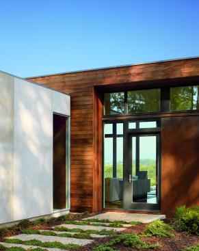 
  The
  Lecicester home is a modern and minimal example of architectural brilliance.
  The home is placed perfectly amongst its wide-open surroundings.&nbsp; A broad range of standard Marvin window and
  door options were all carefully coordinated with the very professional Marvin
  team. The solution of a window wall along the south and west fa&ccedil;ades of the
  upper level brings the outdoors in. This custom configuration of standard
  Marvin products is integral to the vision of the house, as well as the
  economics of its construction. Punched windows in the lower level, also by
  Marvin, contrast nicely with the expression of the main living area. A
  continuous transom of glass at the entry fa&ccedil;ade allows morning light to
  dapple across the interior ceiling. The fenestration was integral to the very
  premise of the house, unifying the interiors with the site’s mountain
  views.&nbsp;