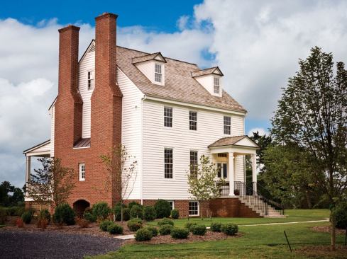A pair of chimneys, visible from a distance, helps define the hom's bold silhouette against the skyline.