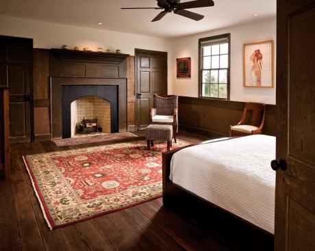 Along with several fireplaces (like this one in the master bedroom), newly added spray-foam insulation helps keep the home's interior temperatures constant.