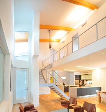 Soaring ceilings and large windows let in abundant daylight. Low-E windows from PGT—boasting a U-value of 0.38 and a SHGC of 0.31—help reduce heat gain from the hot Florida sun.