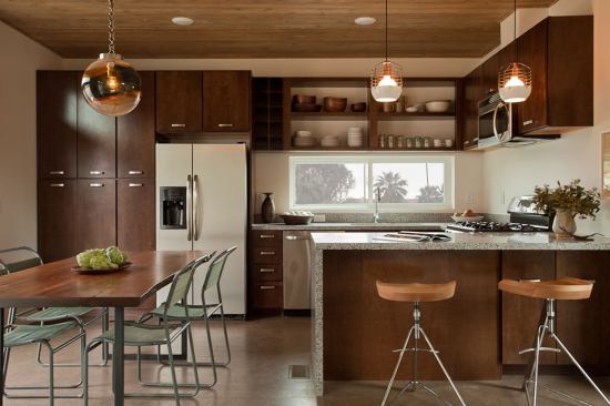 The eat-in kitchen features Energy Star appliances, Greenguard-certified Caesarstone countertops, and ample storage space.